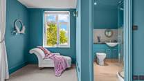 Bedroom 2 has a stylish en suite shower-room, and a chaise longue for quiet moments.