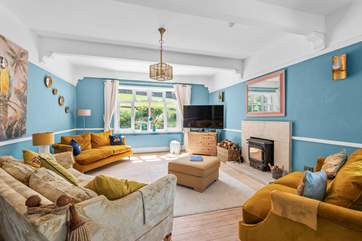 Luxurious furnishings and a warming wood-burner await in the main sitting-room.