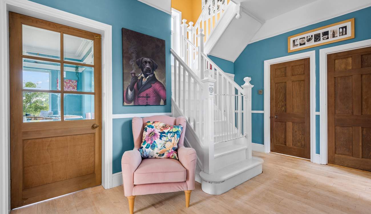 The beautiful stairs lead up from the hallway to the first floor.