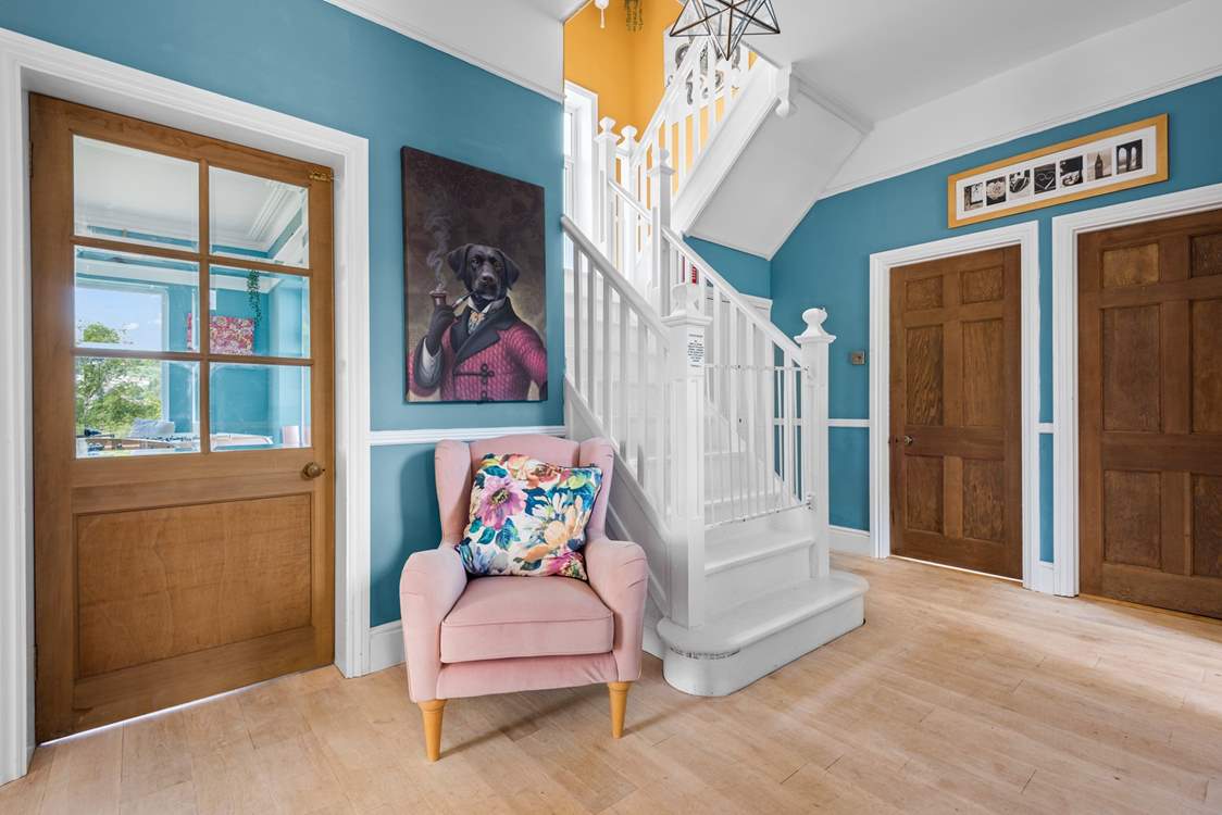 The beautiful stairs lead up from the hallway to the first floor.