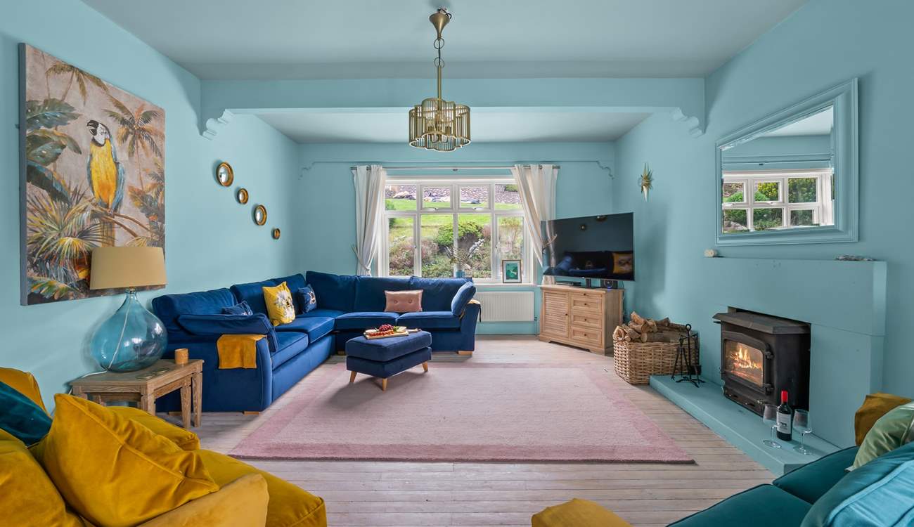 Luxurious furnishings and a warming wood-burner await in the main sitting-room.