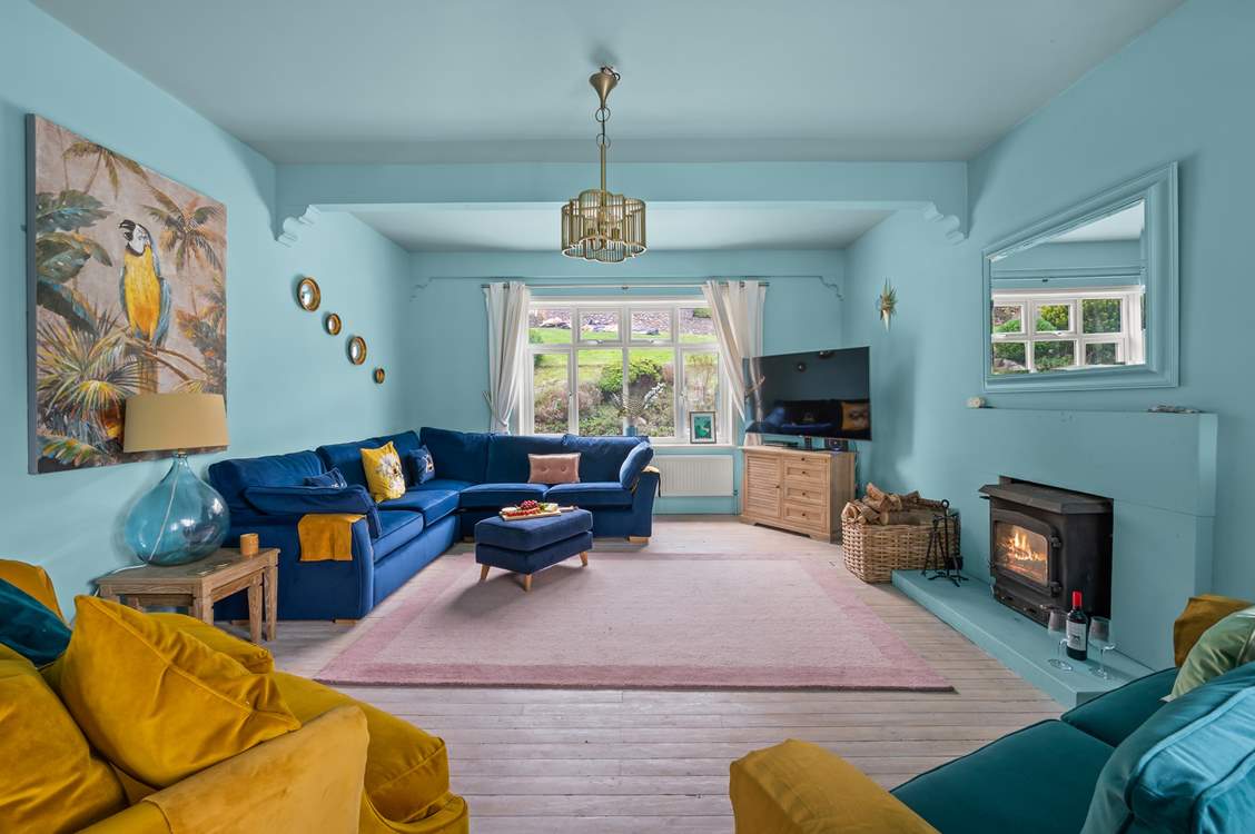 Luxurious furnishings and a warming wood-burner await in the main sitting-room.