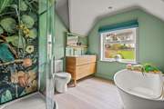 The swish family bathroom has a bath and separate shower cubicle.