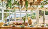 Enjoy sociable dining with a stunning waterside view. - Thumbnail Image