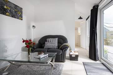 The bedroom is through the sitting-room at the end of the barn.