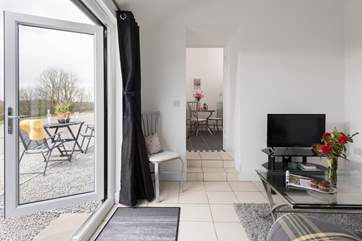 The kitchen is two steps up from the sitting-room.