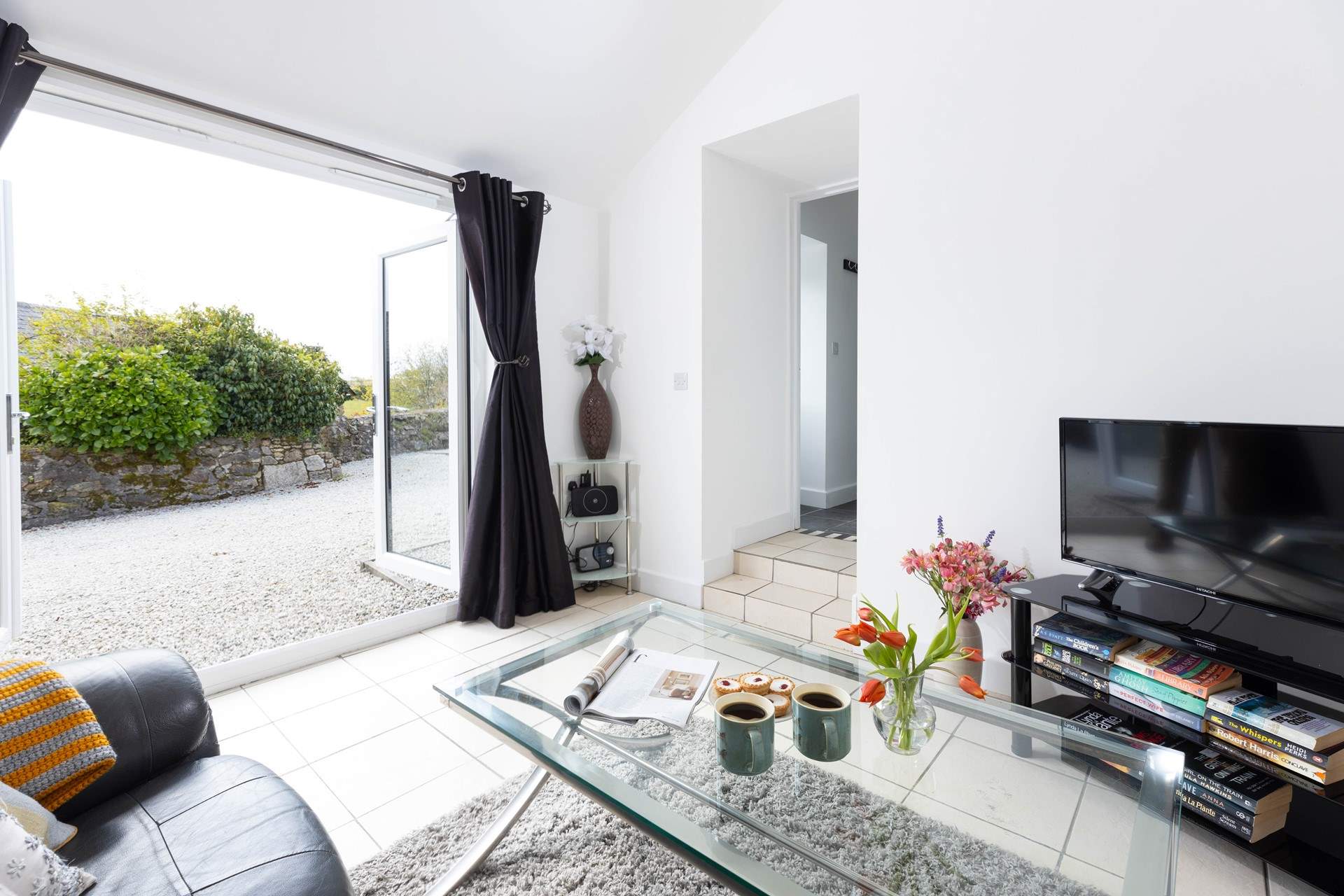 Double doors open to let to cool air breeze through in the summer.  The two steps lead up to the kitchen/diner. 