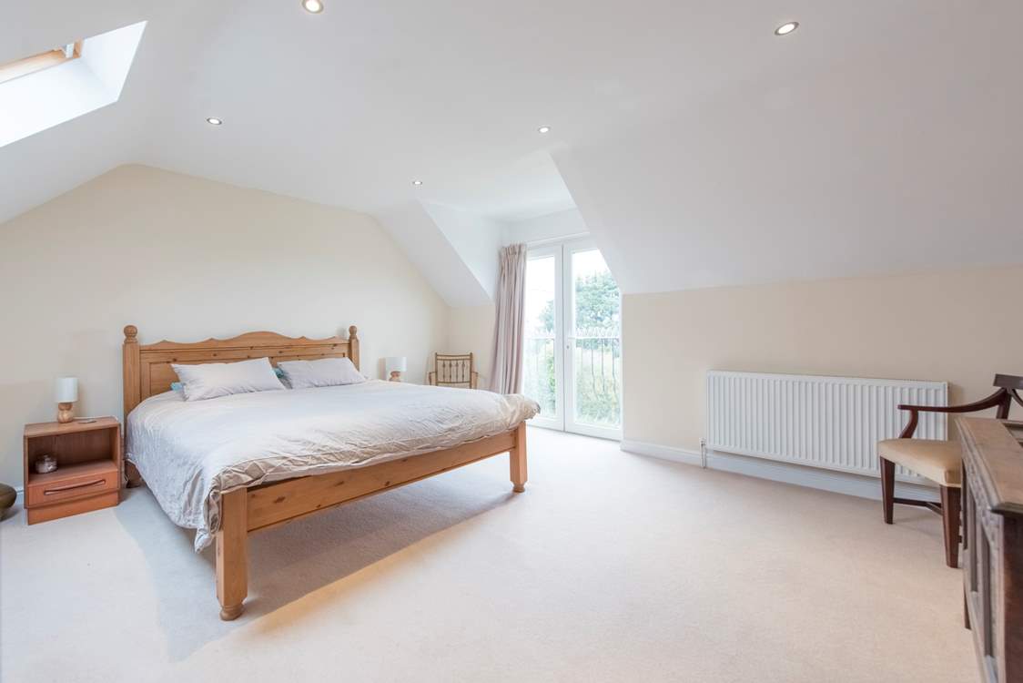 The principal bedroom with a super-king bed and en suite shower-room.