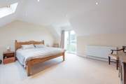 The principal bedroom with a super-king bed and en suite shower-room.