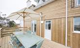 The rear terrace, accessed through the kitchen and home to a large outdoor dining-table. - Thumbnail Image