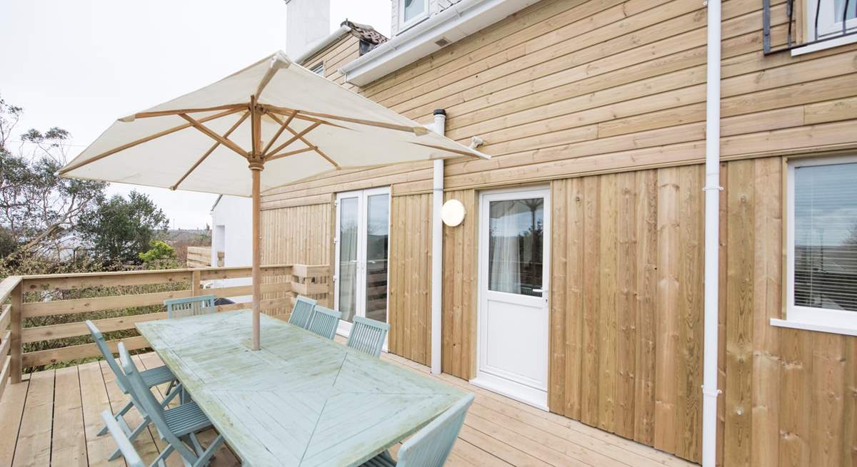 The rear terrace, accessed through the kitchen and home to a large outdoor dining-table.