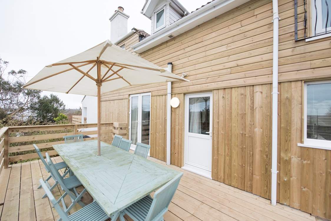 The rear terrace, accessed through the kitchen and home to a large outdoor dining-table.