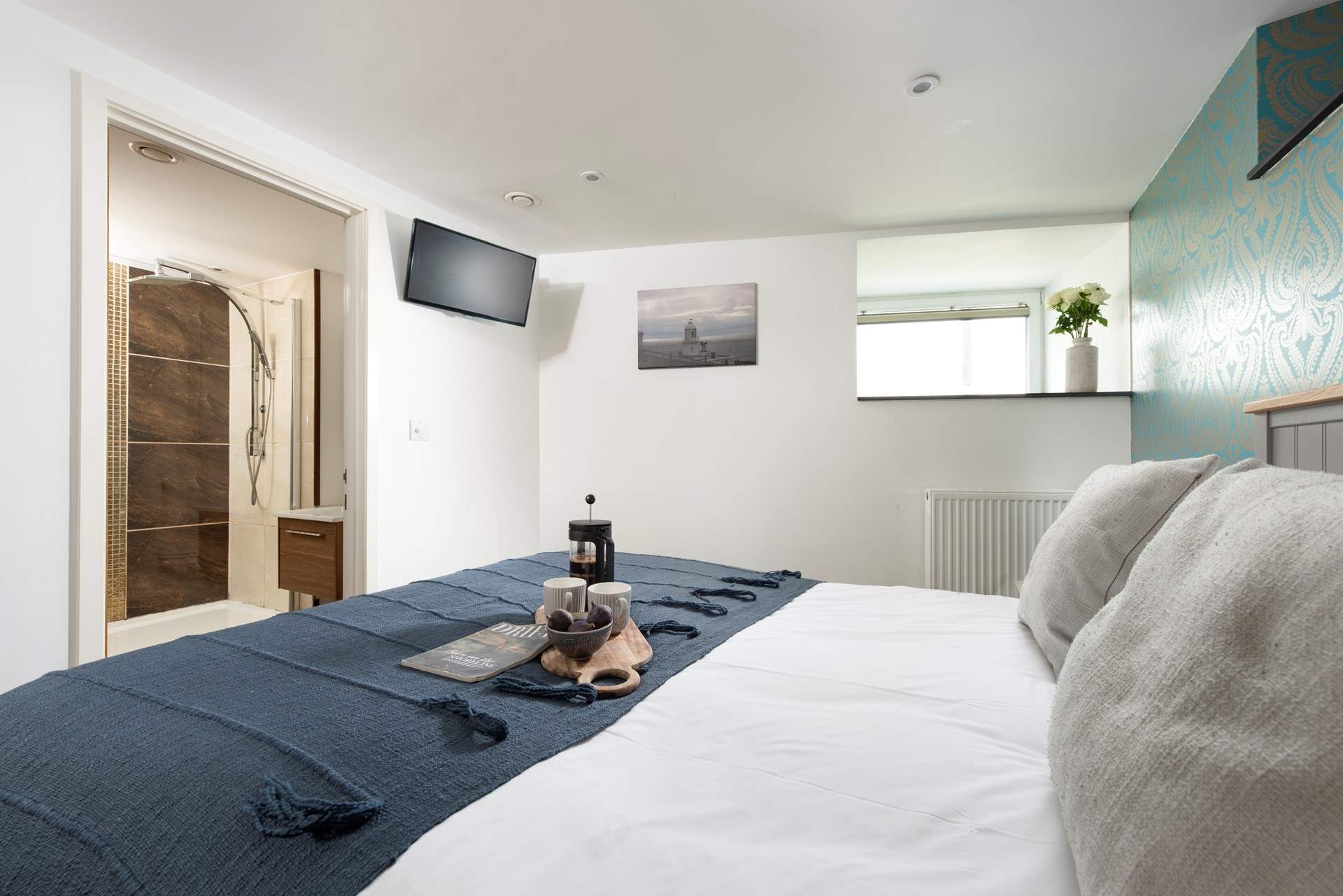 The main bedroom has a TV and an en suite shower-room.