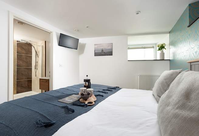 The main bedroom has a TV and an en suite shower-room.