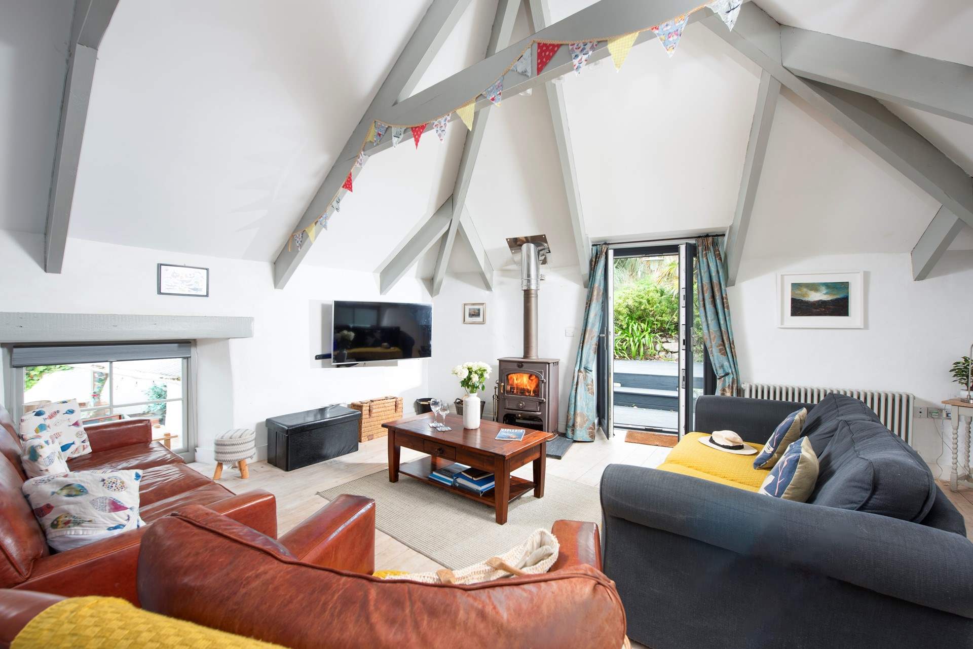The reverse level open plan living-area has doors leading out to the huge enclosed garden.