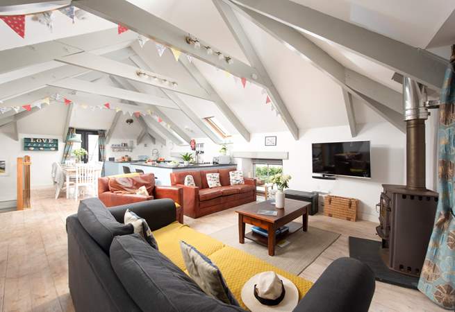 A space to sit back and relax, the stairs lead down to the three bedrooms.