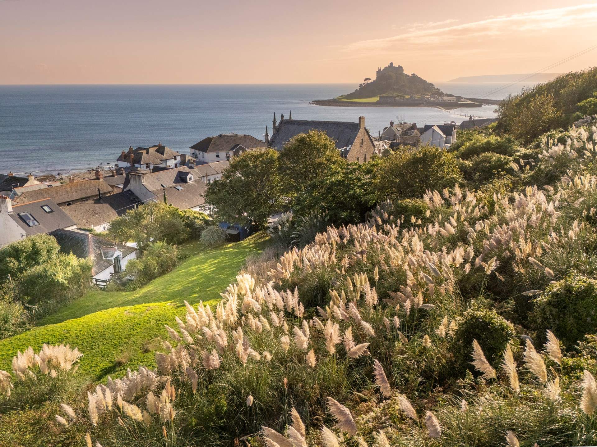 Welcome The Old School Room with sea views from the enclosed garden, plenty of room to play and for your four legged friend to run. The cottage is the white property nestled within its lush garden.