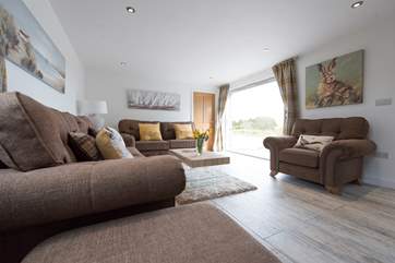 Bi-fold doors lead out to the front terrace and garden.