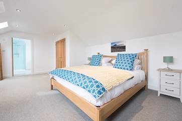 The master bedroom with a luxurious en suite bathroom with separate shower.