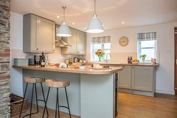 The breakfast-bar doubles up as the dining-area but as you are holiday do you really want to cook?