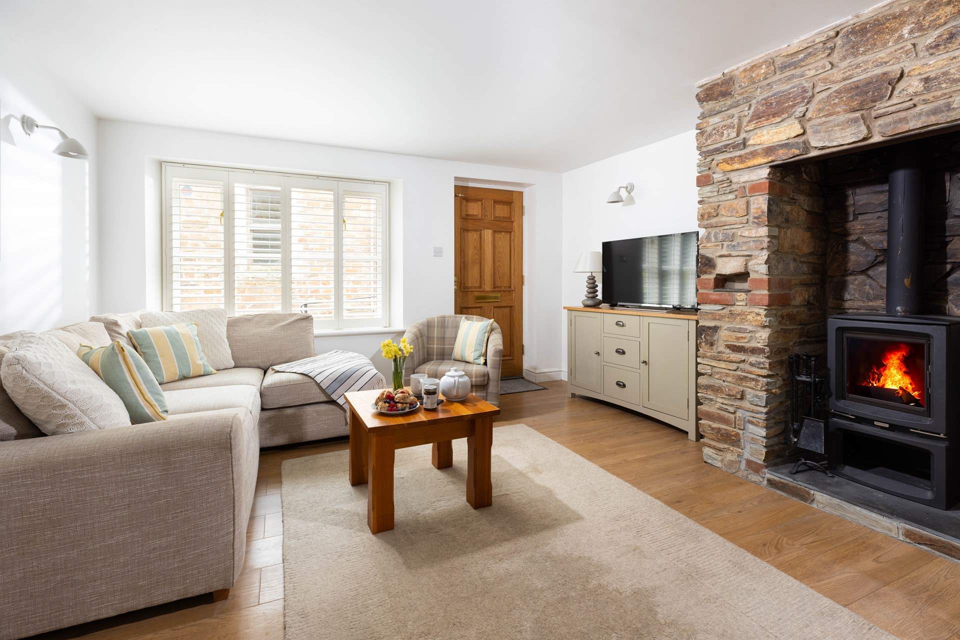 Kick back and relax on the sofa in front of the wood burner on the ground floor. 