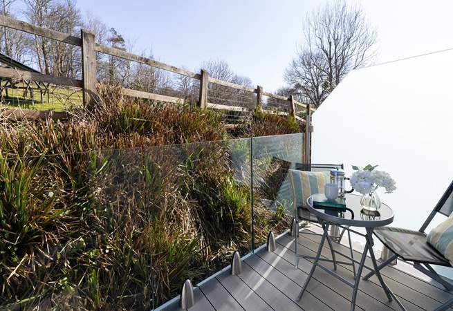 Enjoy a refreshing drink on the private balcony. 