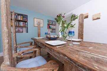 The driftwood dining-table where there is room for guests.
