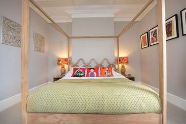 The master bedroom features a gorgeous super-king four-poster bed.