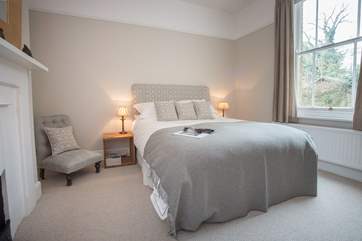 Looking out to patio-area, this double bedroom has a very calming feel.