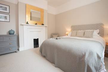With lots of space and an ornamental fireplace.