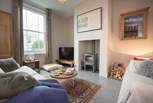 The cosy sitting-room features a wood-burning stove, perfect for the winter months.
