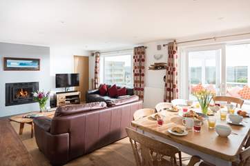The open plan dining and sitting-area. The patio doors lead out into the sun-room and that fabulous view.