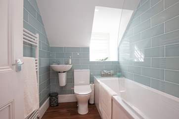 The modern bathroom has been finished with soothing colours, making this an enjoyable place for a long soak in the bath.