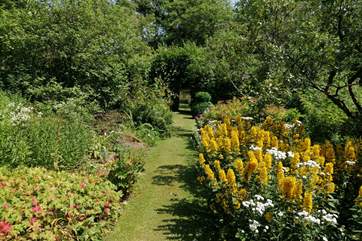 Beautiful grassy pathways lead down to the swimming pool