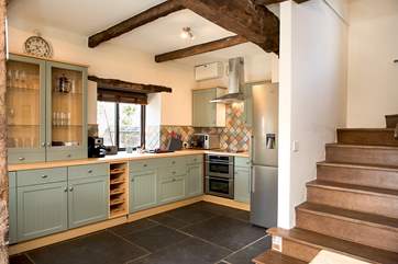 The stairs lead off from the kitchen/dining-area.