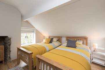 This is the pretty twin bedroom. The sloping ceiling is a real feature of this age of property but do take care of your heads.