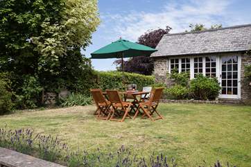 At the back of the cottage there is a wonderful fully enclosed garden with an orchard at the far end. This little stone outbuilding is not in use but guests have a large games-room in the garage.