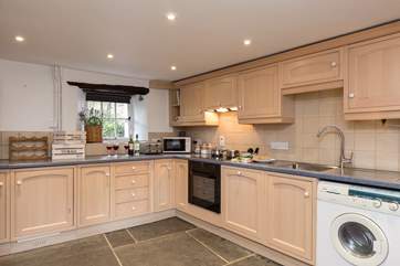 The kitchen has its own door to the outside ( and an outhouse for secure bike storage ) and a couple of steps take you down into the dining-room and snug.