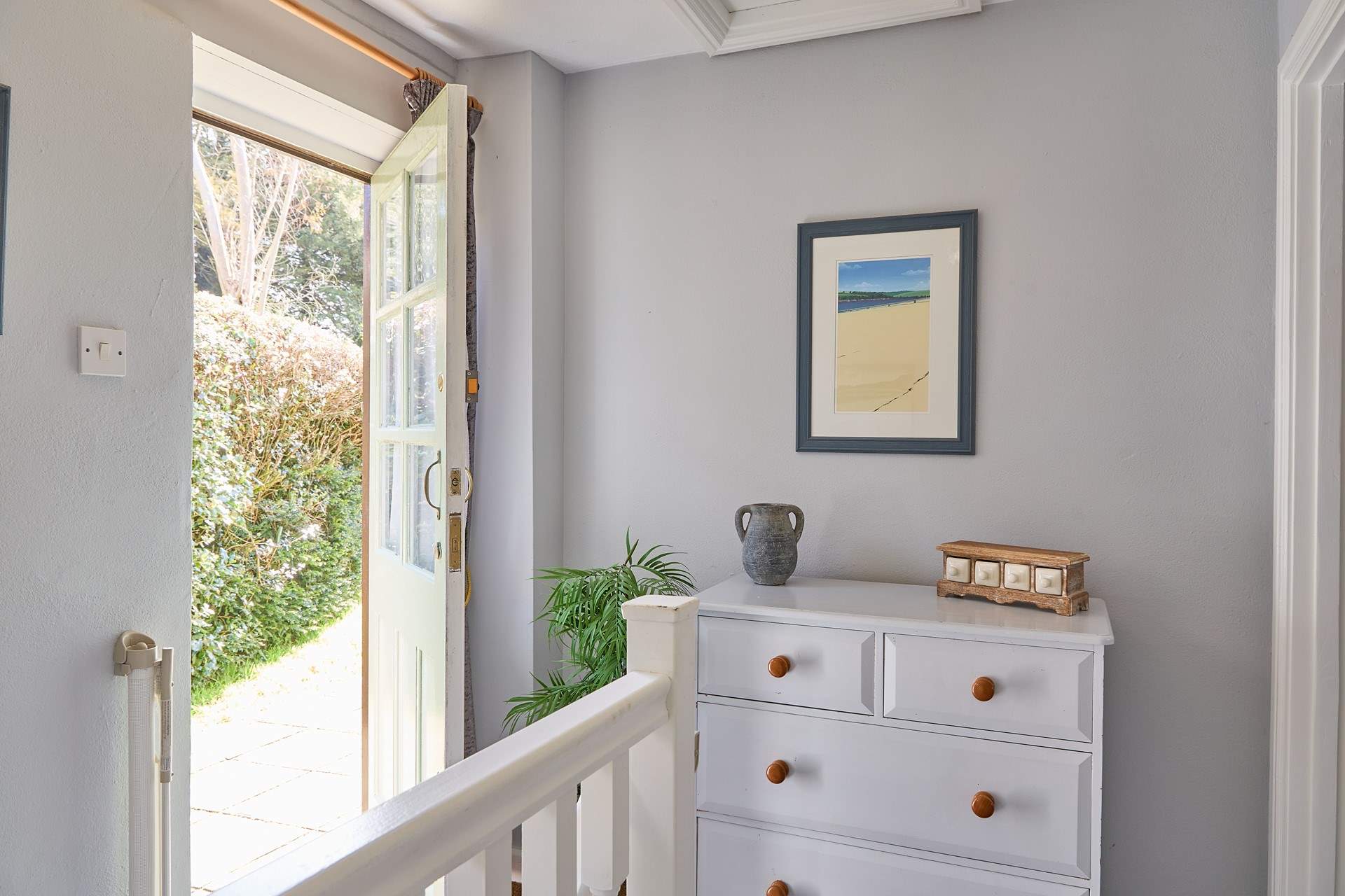 Both bedrooms sit off of the landing, the back door opens up on to the complex. 