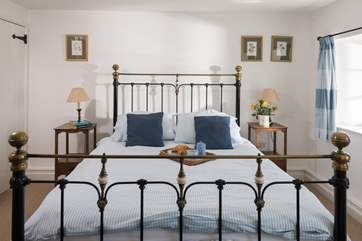 A stylish brass bed in the master bedroom (Bedroom 1).
