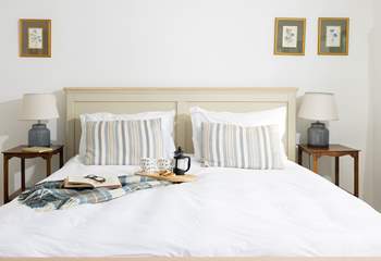 Crisp white linens await your slumber. 