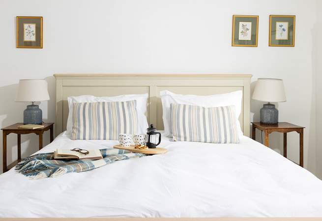 Crisp white linens await your slumber. 