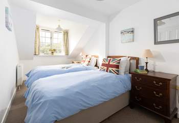 The cosy twin bedroom is tucked away at the back of the cottage. 