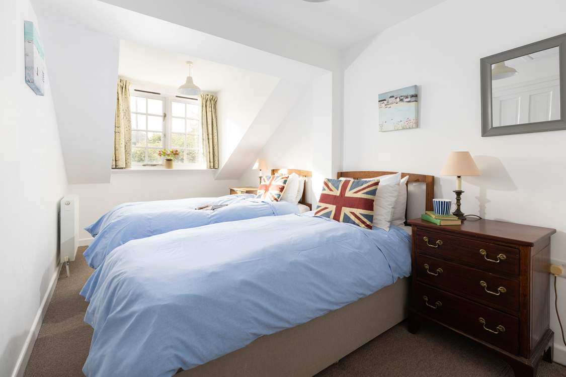 The cosy twin bedroom is tucked away at the back of the cottage.