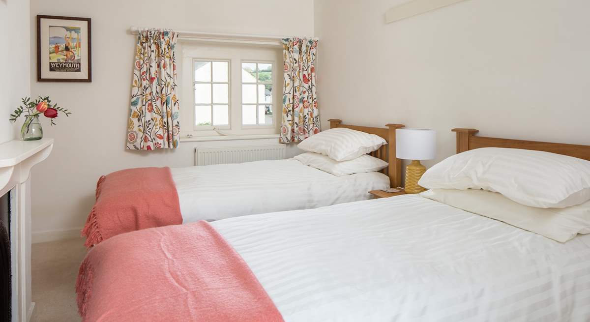 The cheerful twin room looks over the village square at the front and the garden at the back.