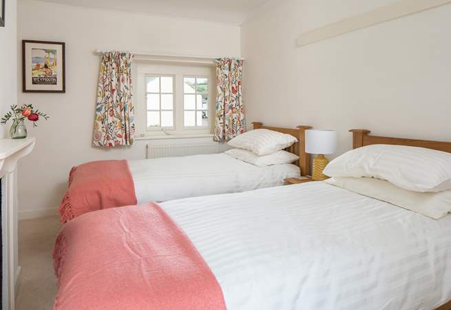The cheerful twin room looks over the village square at the front and the garden at the back.