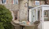 This beautiful listed cottage has a turning staircase, hidden within the curved stone feature seen at the back of the cottage. - Thumbnail Image