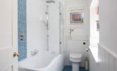 A bath and shower in this bright family bathroom. - Thumbnail Image