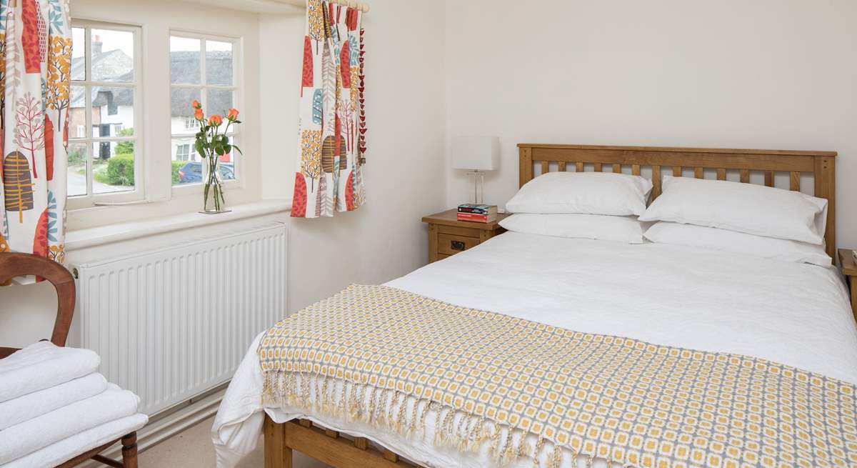 This pretty bedroom has a 5ft bed and looks out over the square.