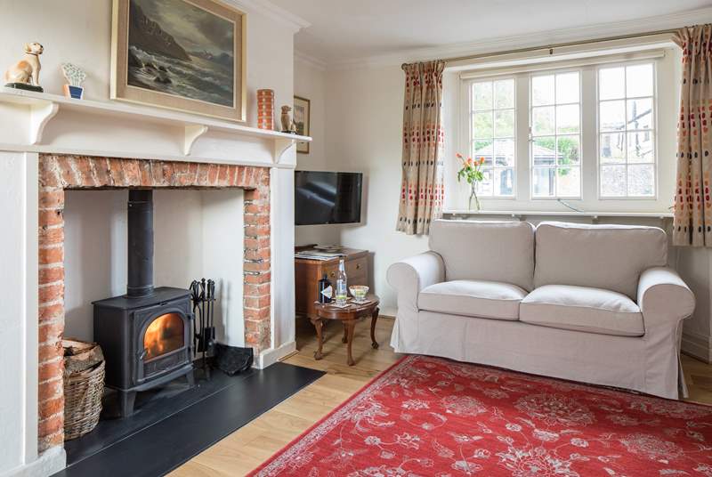 The sitting-room has a cosy wood-burner for chilly evenings.